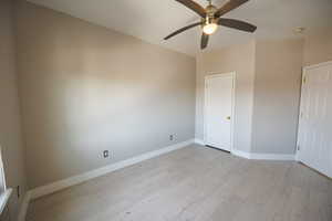 Unfurnished bedroom featuring light wood-type flooring and a ceiling fan