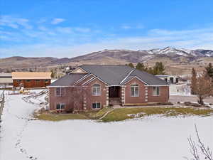 View of front of home featuring brick siding and a mountain view