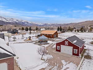 Snowy aerial view with a mountain view and a residential view