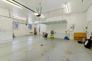 Garage featuring a central vacuum unit and a garage door opener