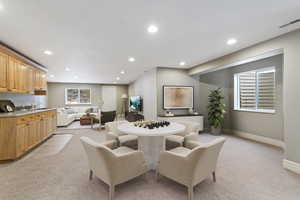 Dining area featuring light carpet and recessed lighting