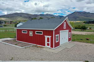 View of outdoor structure featuring a mountain view and driveway