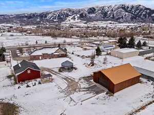 Snowy aerial view featuring a mountain view