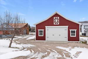 Snow covered garage with a garage