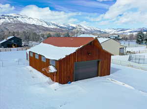 Snow covered structure featuring a mountain view
