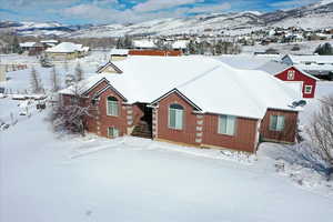 Snowy aerial view featuring a mountain view