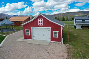 Detached garage with a mountain view and driveway