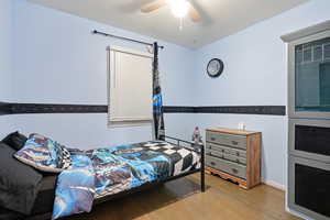 Bedroom featuring a ceiling fan and wood finished floors
