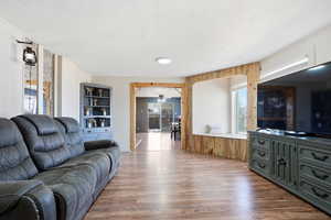 Living room with wood finished floors and a ceiling fan