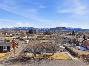 View of mountain backdrop featuring nearby suburban area