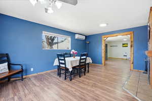 Dining space featuring light wood-style flooring and baseboards