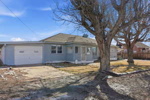 View of front of property featuring concrete driveway, roof with shingles, brick siding, and an attached garage