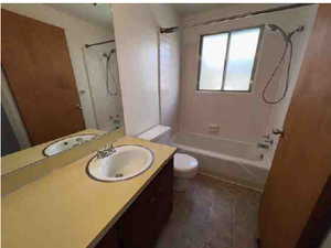 Bathroom featuring vanity and washtub / shower combination