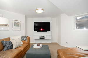 Carpeted living room with baseboards
