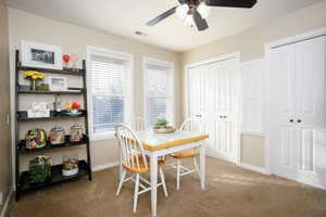 Dining area with carpet flooring and ceiling fan