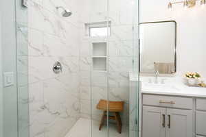 Bathroom with vanity and a shower stall