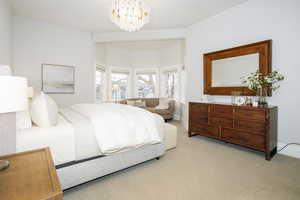 Bedroom with carpet and suspended lighting