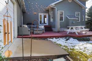 Rear view of house featuring a wooden deck and an outdoor lounge area