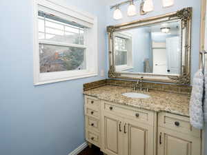 Bathroom with vanity and tasteful backsplash