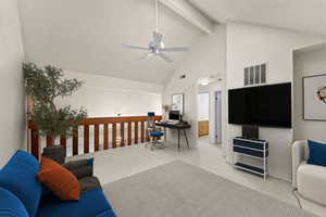 Living room with light colored carpet, a desk, and a ceiling fan