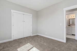 Unfurnished bedroom with carpet and a closet