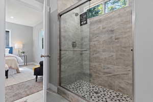Full bathroom with carpet floors, ensuite bathroom, a shower stall, and tile patterned flooring