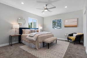 Carpeted bedroom featuring ceiling fan, multiple windows, and recessed lighting