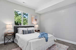 Bedroom featuring baseboards and carpet