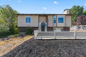 Bi-level home featuring brick siding and a chimney