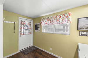 Foyer featuring dark wood finished floors and a textured wall