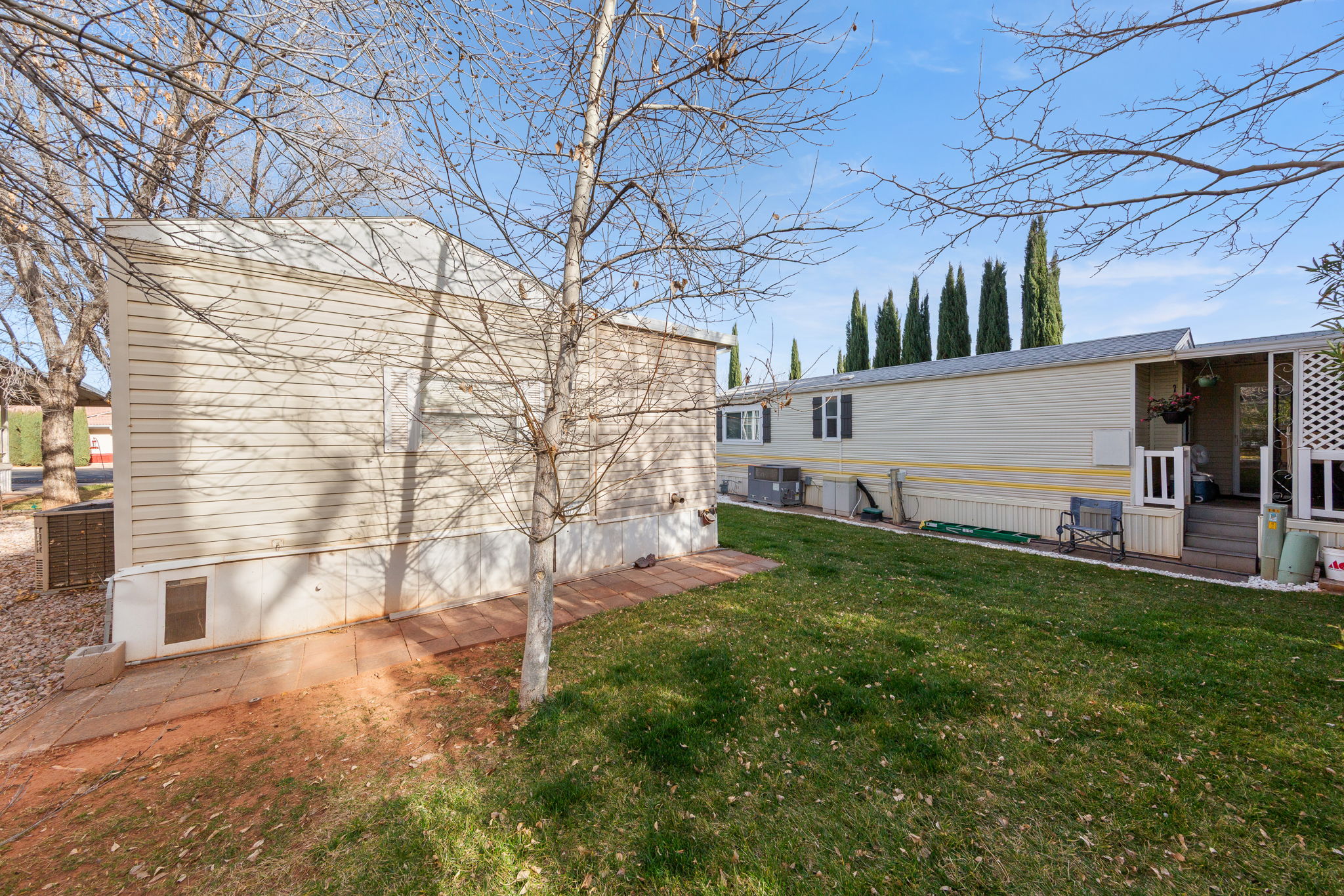 Back of house featuring a patio and a lawn