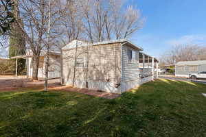 View of side of property with a yard