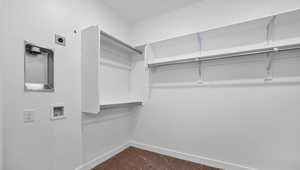 Walk in closet featuring dark carpet