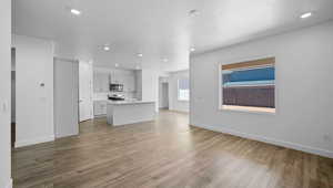 Unfurnished living room featuring light wood-type flooring and recessed lighting