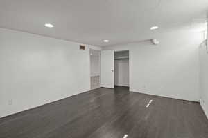 Unfurnished bedroom with dark wood finished floors, a closet, recessed lighting, and a textured ceiling