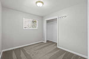 Unfurnished bedroom with carpet flooring and a closet