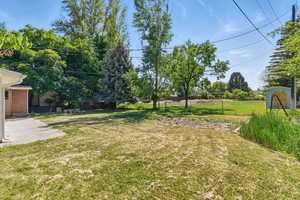 Fenced backyard featuring a patio and a storage unit