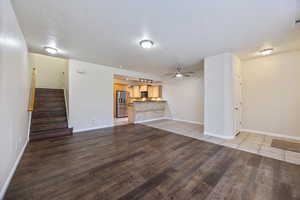 Unfurnished living room with light wood finished floors and ceiling fan