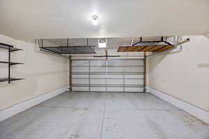 Garage featuring baseboards