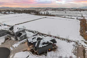Snowy aerial view with mountain backdrop