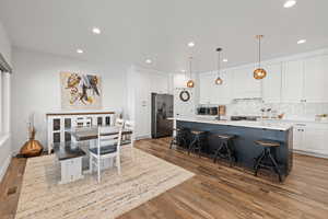 Semi-formal dining space with recessed lighting and LVP flooring