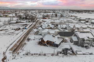 Snowy aerial view with mountain backdrop