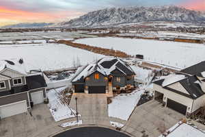 Snowy aerial view with mountain backdrop