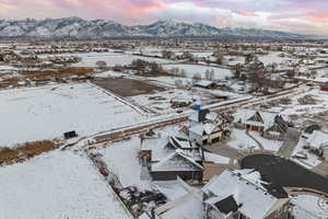 Snowy aerial view with mountain backdrop