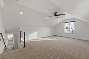 Second floor bonus space featuring carpet floors, light paint, ceiling fan, and natural light