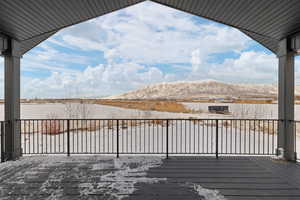 View of spacious covered Trex deck with agricultural and mountain views