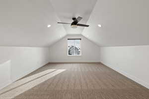 Bonus room featuring light colored carpet, a ceiling fan, and recessed lighting