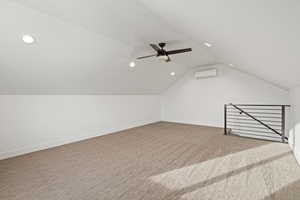 Bonus room with light carpet, vaulted ceiling, ceiling fan, and recessed lighting