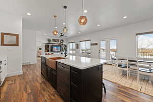 Open concept floorplan featuring large kitchen, spacious semi-formal dining area, living room, and access to a covered back deck.