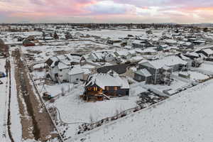 Snowy aerial view with mountain backdrop